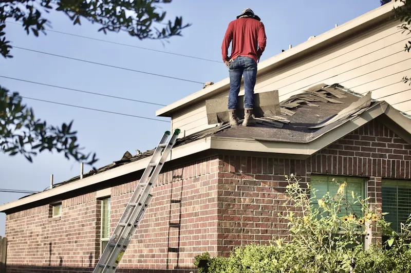 Professional roofer working on a residential roof in Randleman